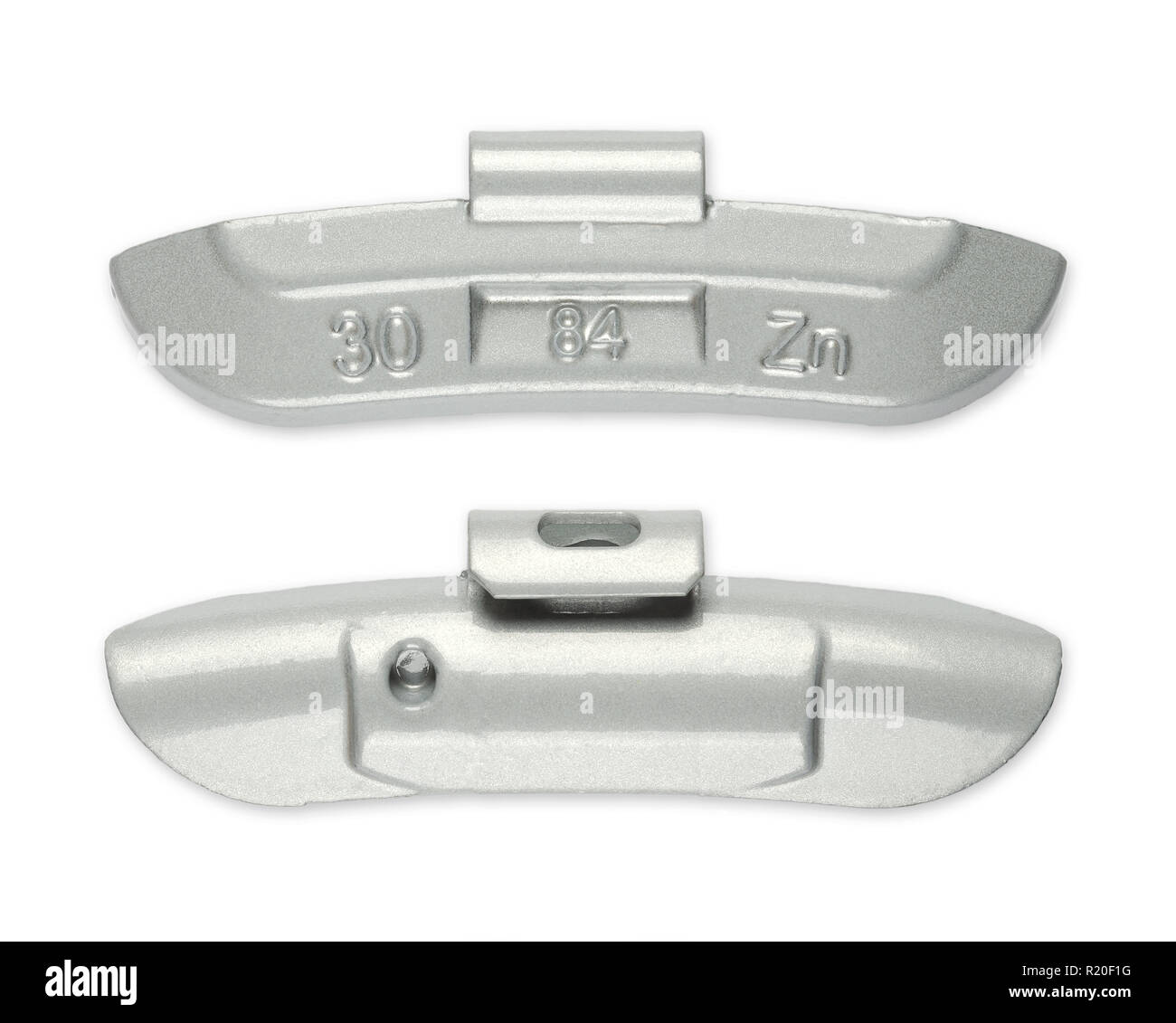 Clip-on zinc tire weight, front and back side, from above. Correction wheel weight, to mount on a rim to create a better mass distribution and balance Stock Photo