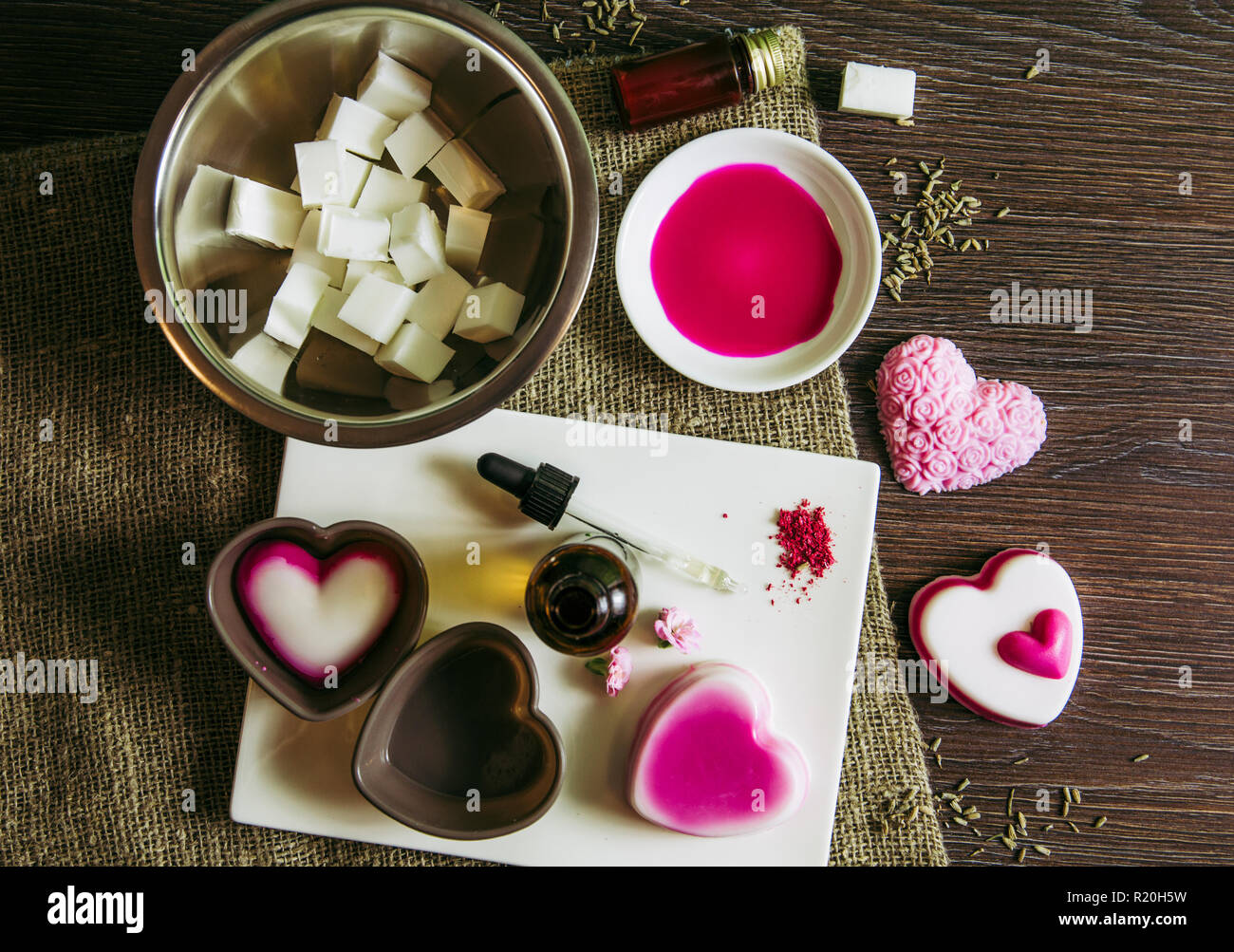 Making soap from pour and melt soap base concept. Soap making ingredients on brown wooden