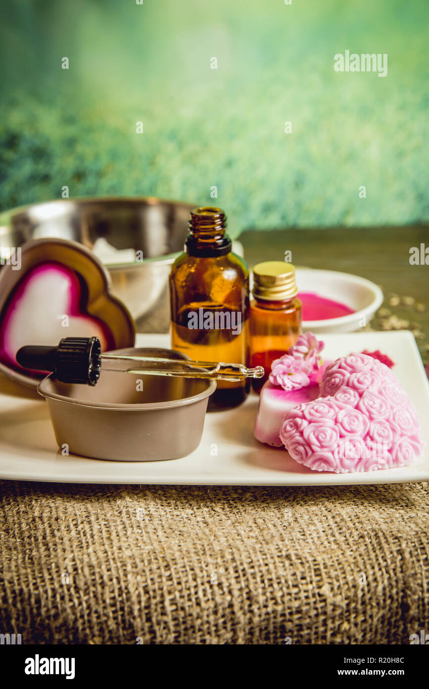 Making soap from pour and melt soap base concept. Soap making ingredients on brown wooden