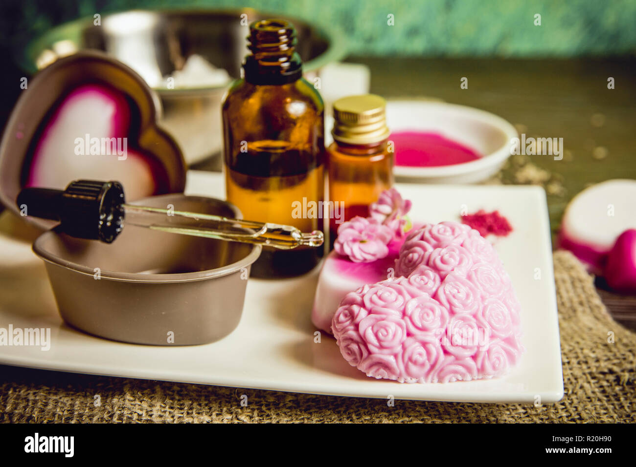 Making soap from pour and melt soap base concept. Soap making ingredients on brown wooden