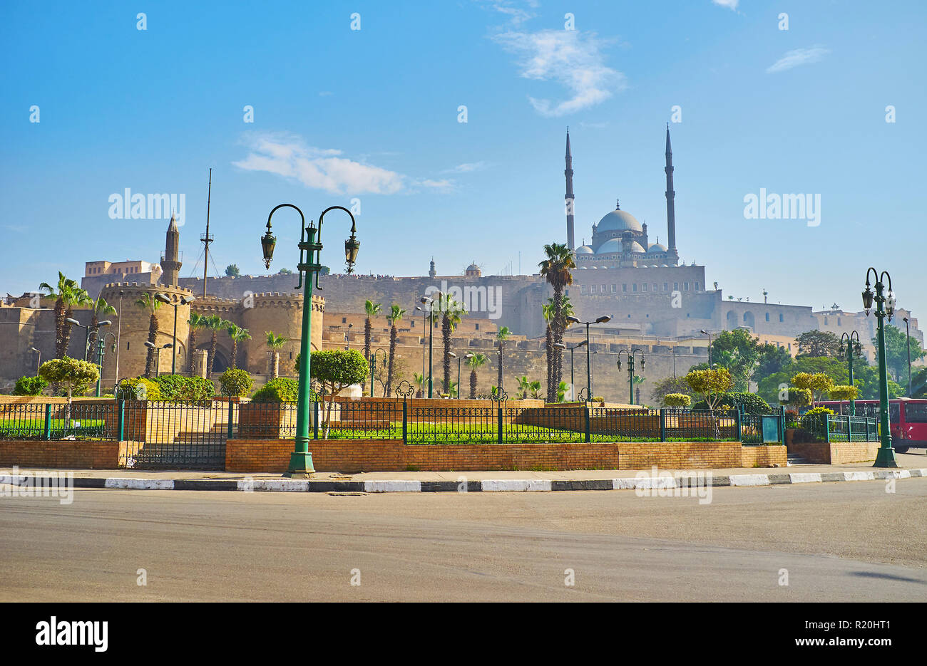 The view on Bab Al-Azab Gate, massive ramparts and stunning  Muhammad Ali Pasha (Alabaster) Mosque of Saladin Citadel behind the small park amid Salah Stock Photo