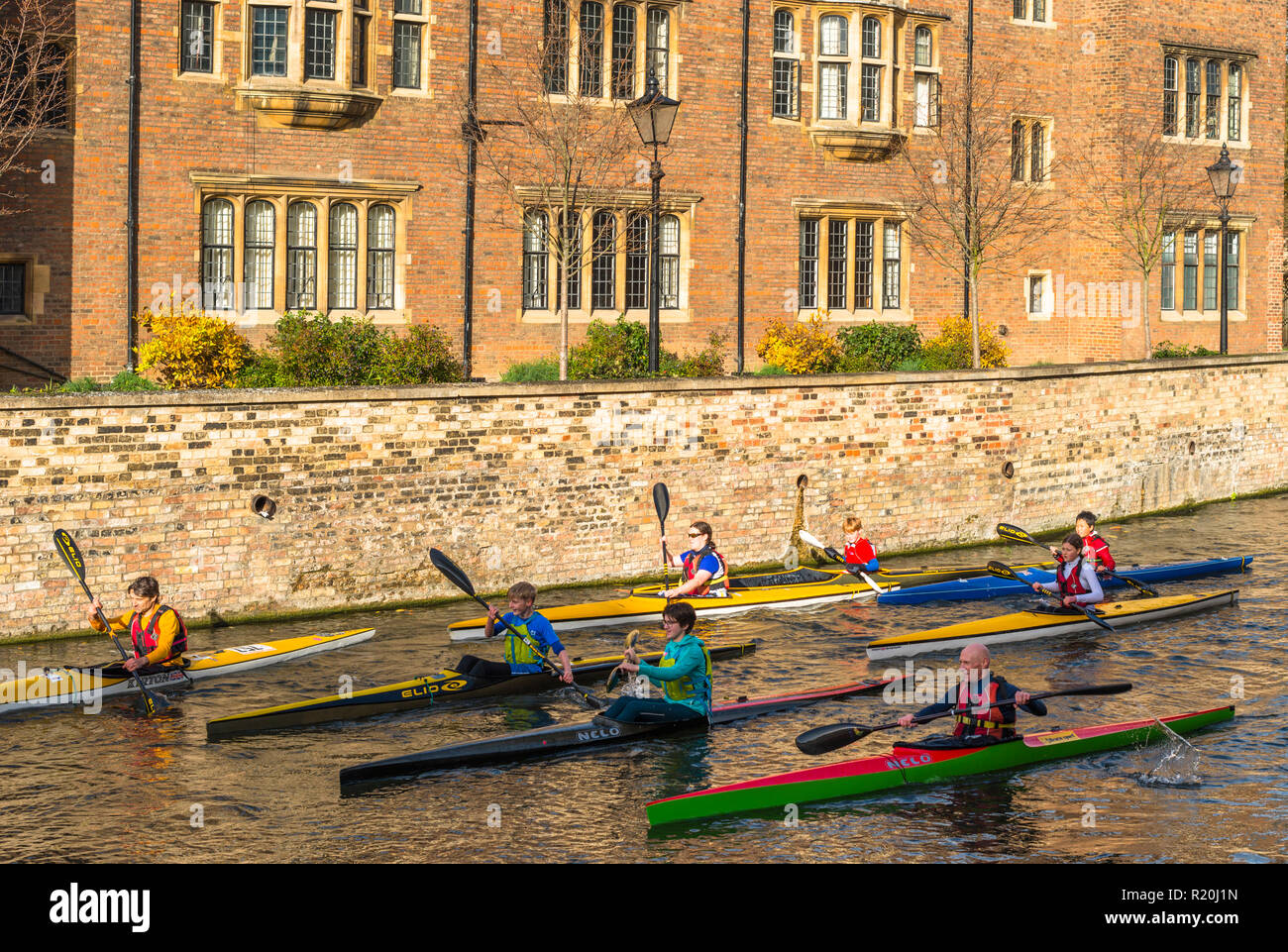 Canoeists pass a punt on river Cam with Magdalene College to rear. Cambridge University. England. UK. Stock Photo