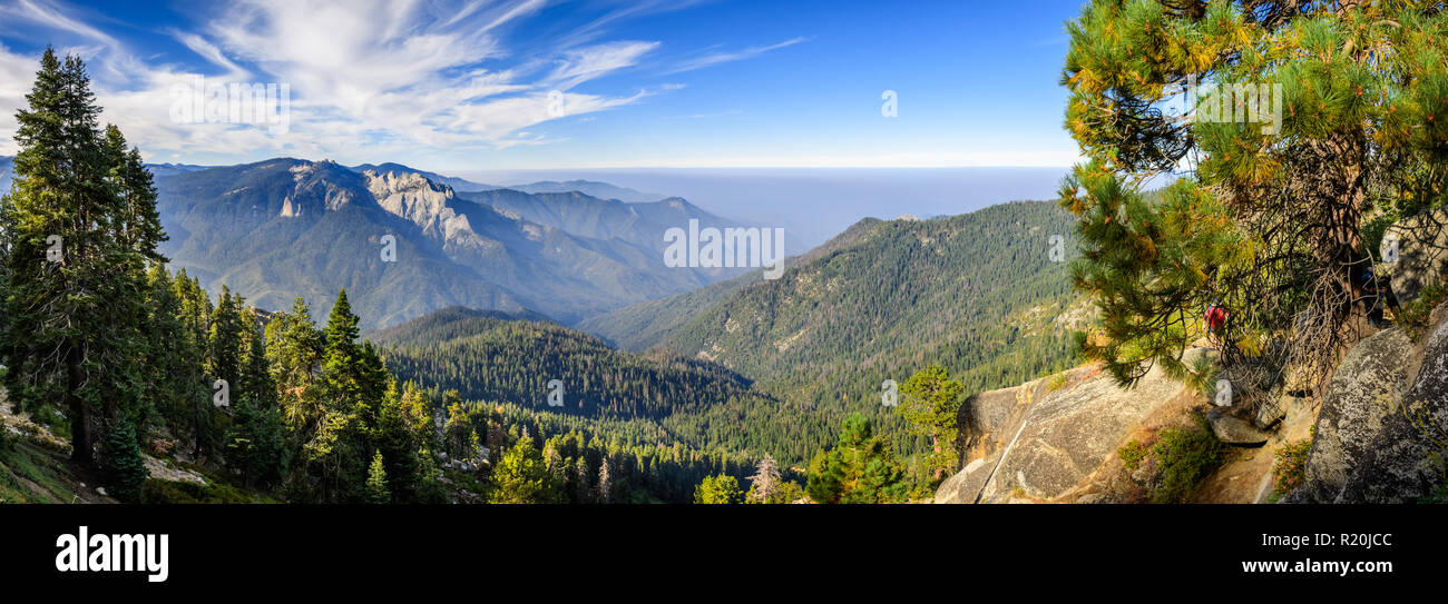 Landscape in Sequoia National Park in Sierra Nevada mountains on a sunny day; smoke from wildfires visible in the background, covering the Fresno area Stock Photo