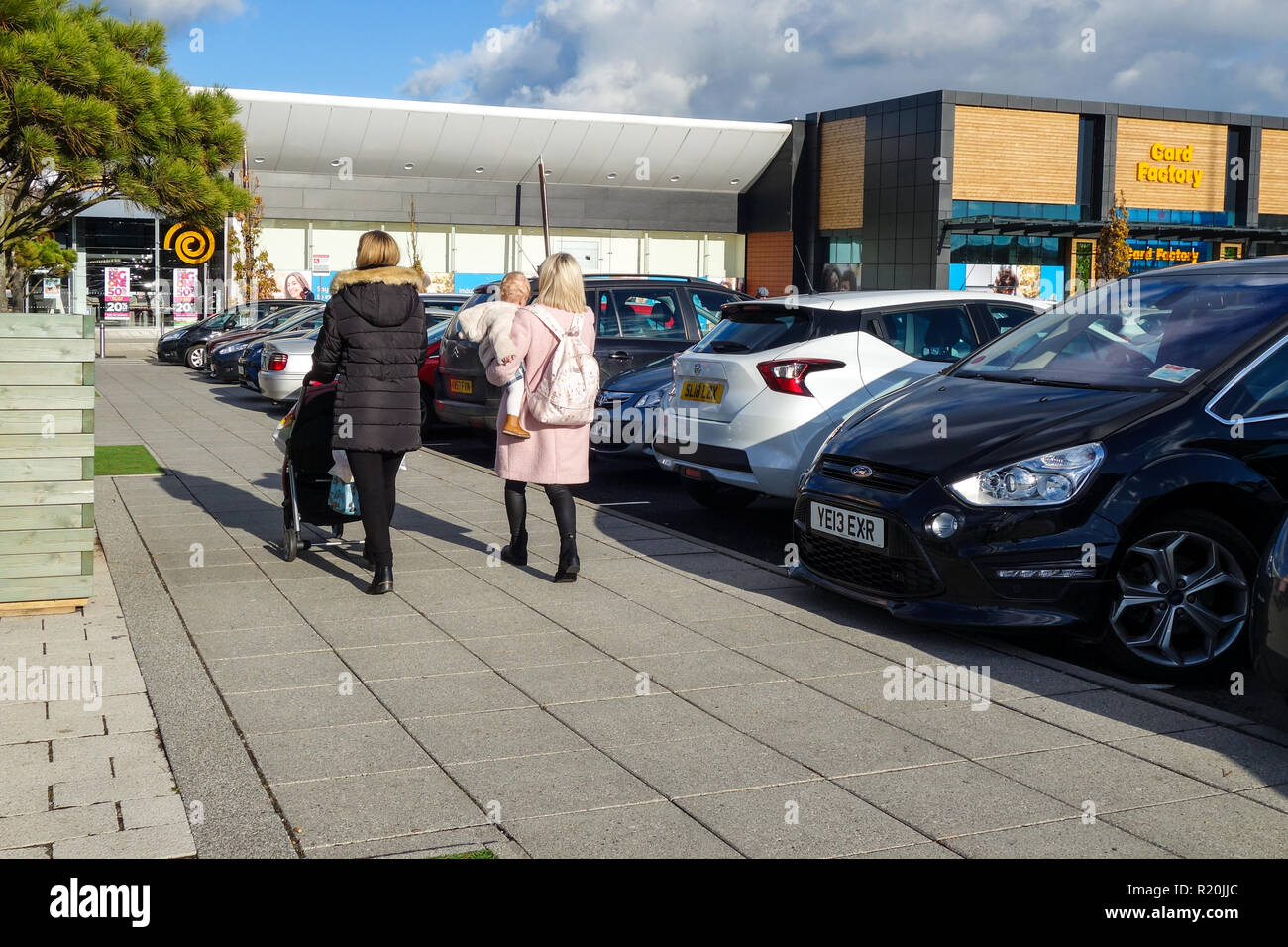 Two shoppers and baby at Retail Park, Shops and car parks in Edinburgh