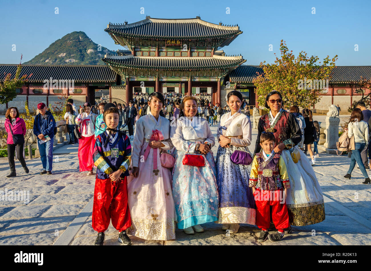 Group of friends pose for a picture at Gyeongbokgung Palace in Seoul, dressed in traditional Korean dress, the hanbok. Stock Photo