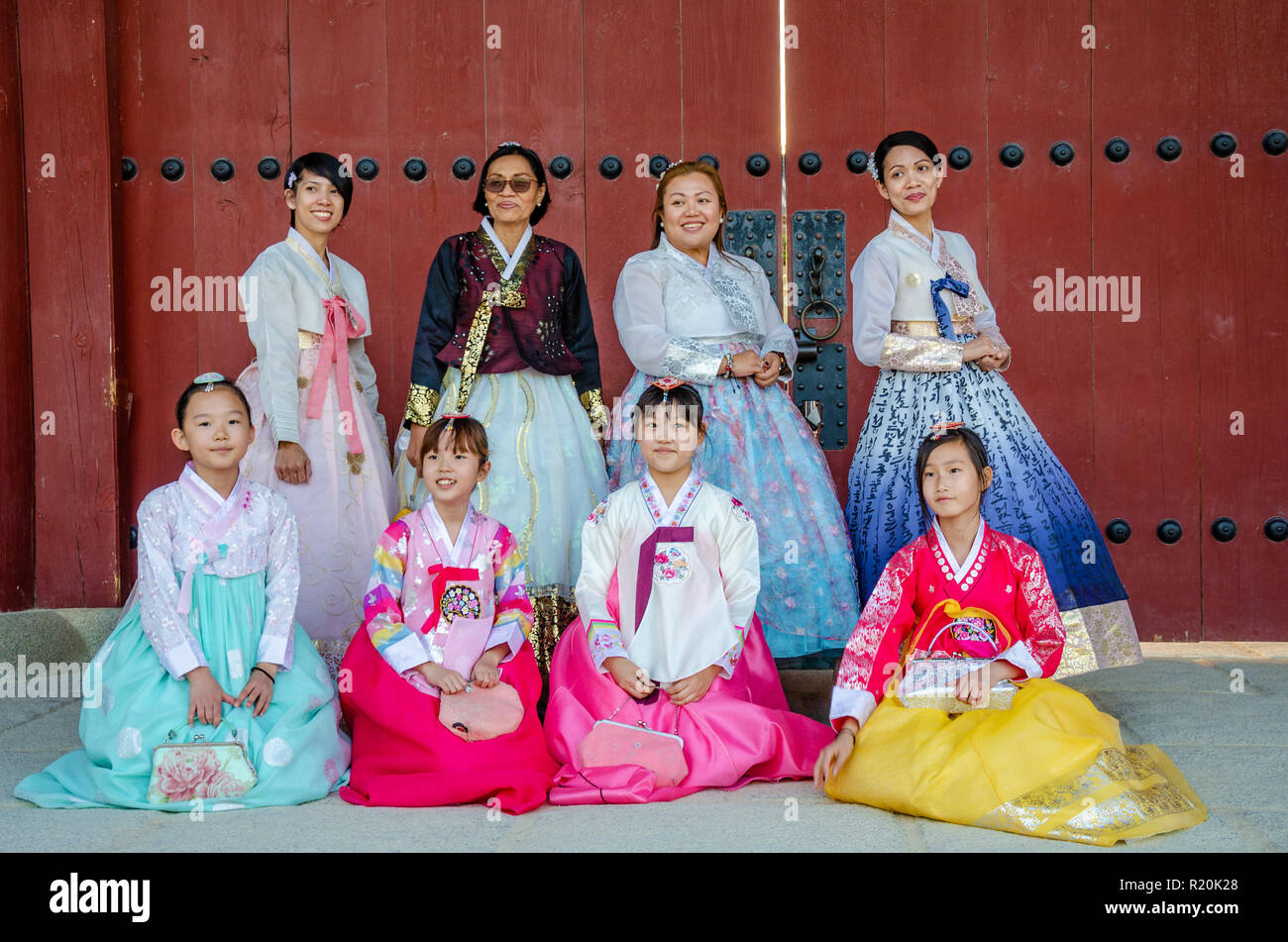 A group of ladies and girls pose for a picture, wearing traditional Korean dress, the Hanbok. Stock Photo