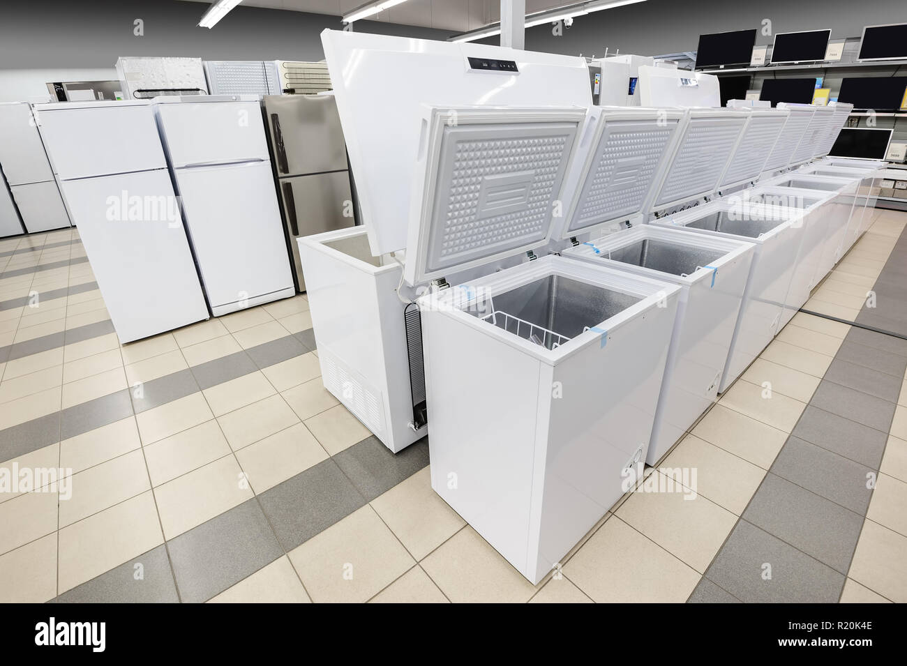 rows of freezers and refrigerators in appliance store Stock Photo