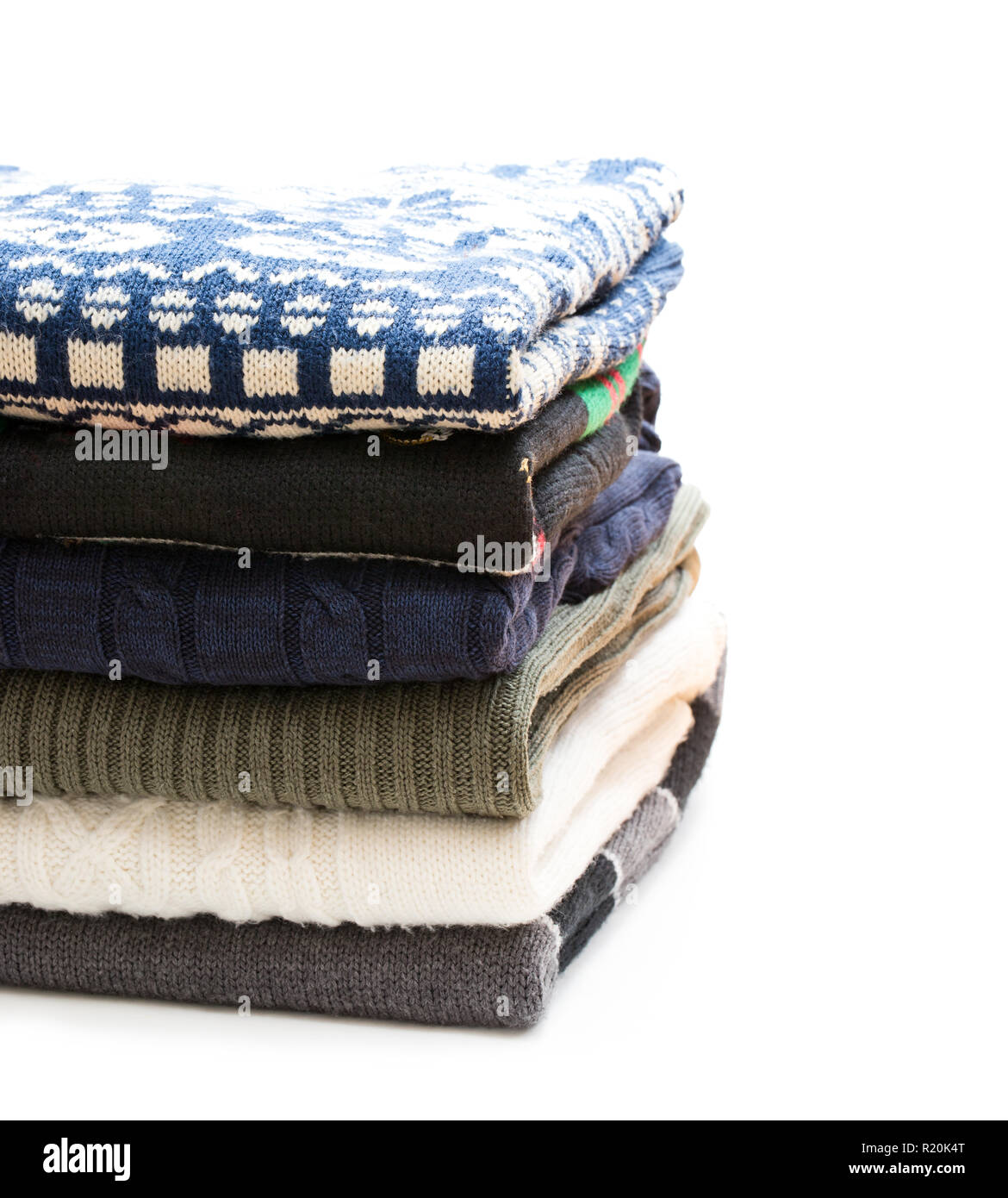 Folded  knitwear sweaters isolated on white Stock Photo