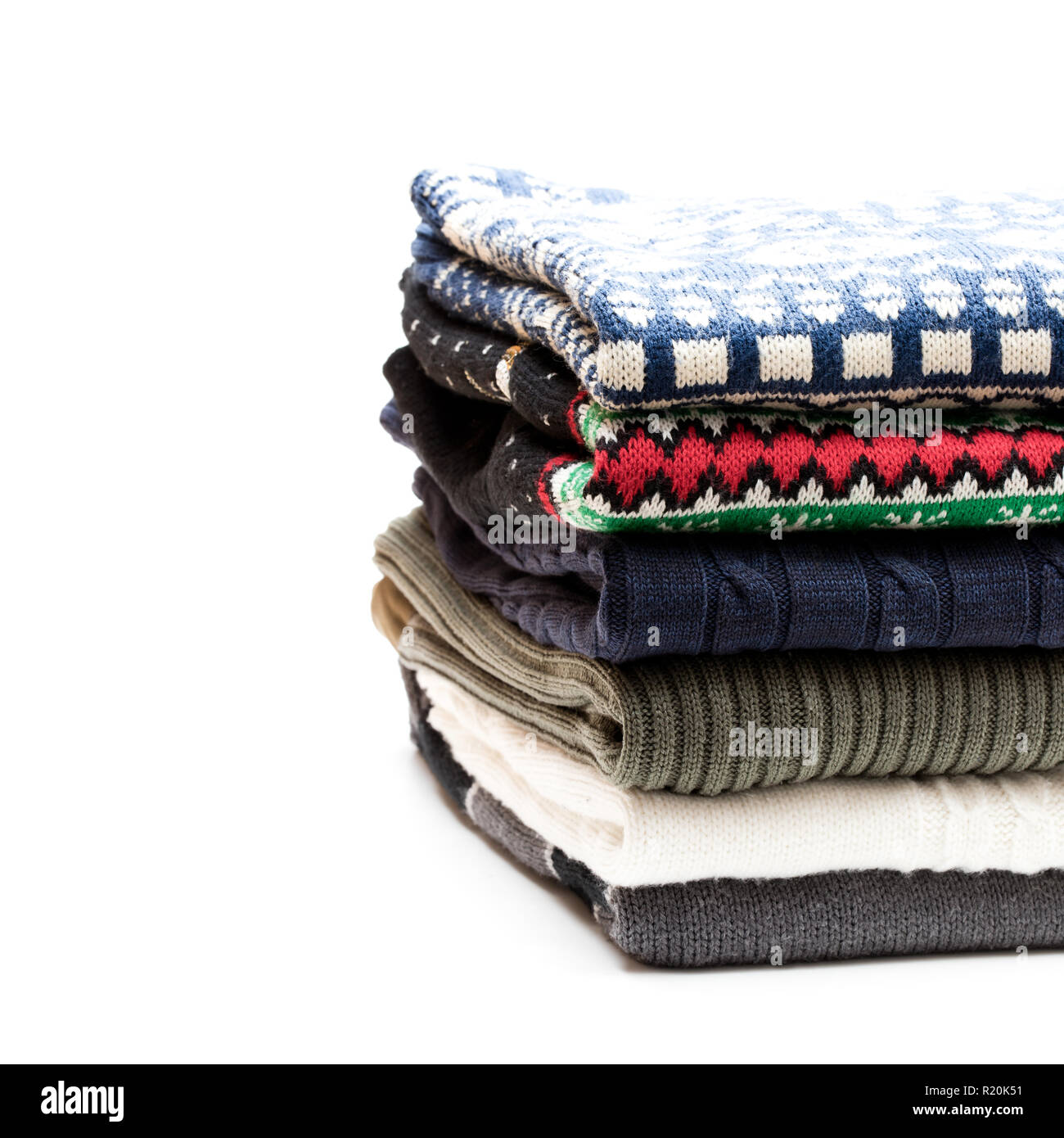 Folded knitwear sweaters isolated on white Stock Photo