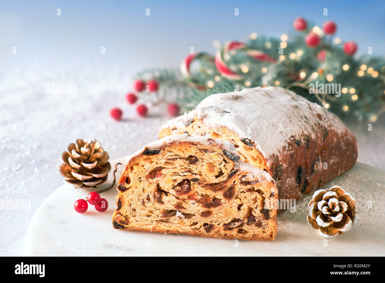 Christmas stollen on whiteblue festive background with fir twigs