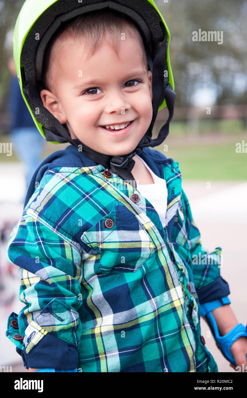 A happy little boy about to go skating outside. Stock Photo