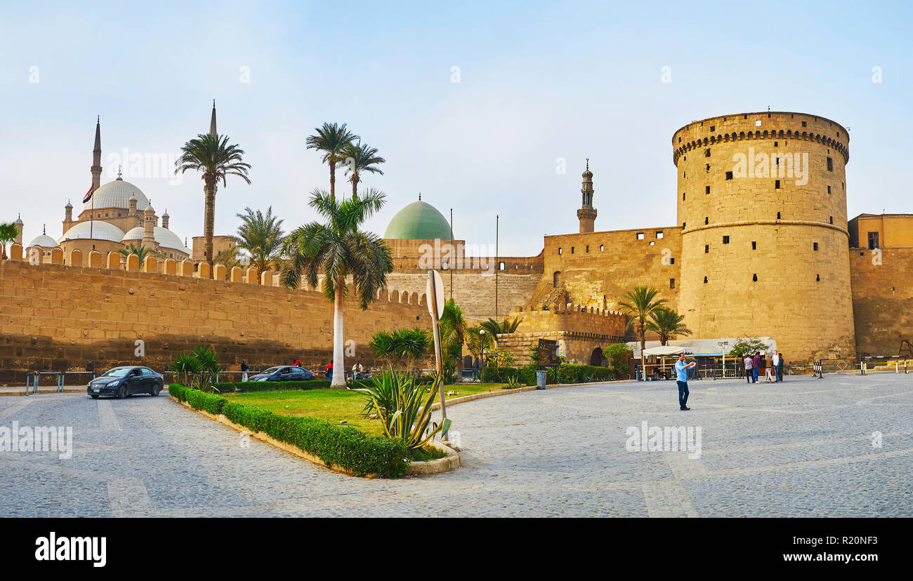 CAIRO, EGYPT - DECEMBER 21, 2017: The tall medieval wall of Saladin Citadel with preserved watchtower hides the old mosques of Muhammad Ali and Al-Nas Stock Photo