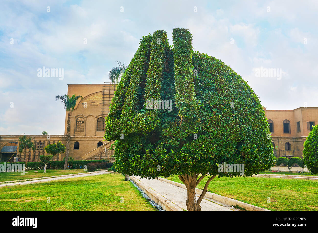 The ornamental garden of Saladin Citadel, with trimmed trees, decorated with Arabic inscription 'Allah', Cairo, Egypt. Stock Photo