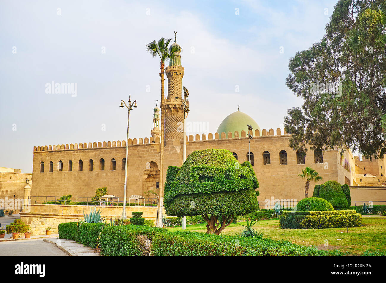 Relax in ornamental garden of Saladin Citadel with a view on medieval Al-Nasir Muhammad Mosque, Cairo, Egypt. Stock Photo