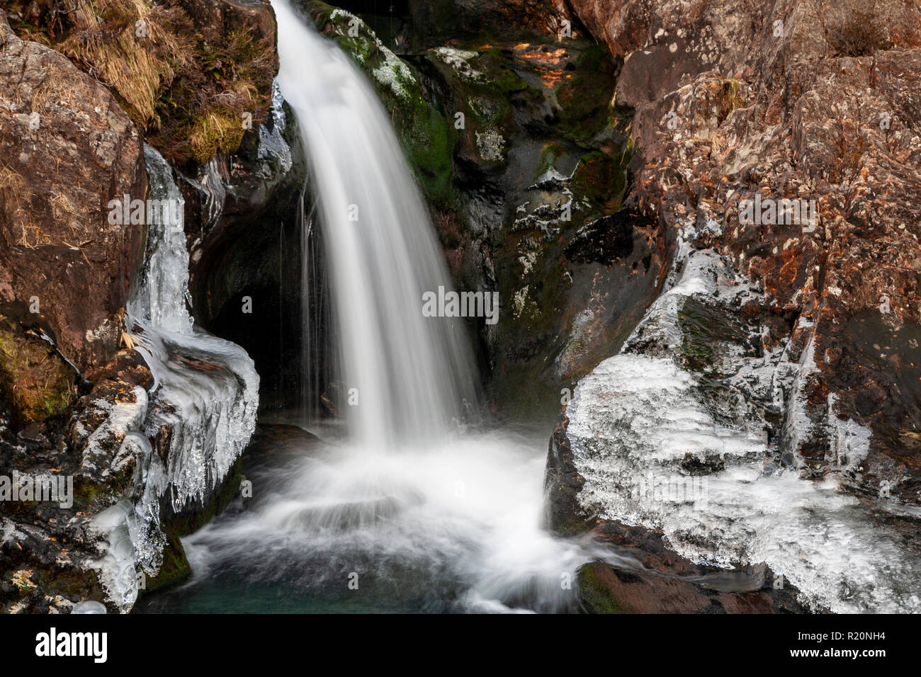 Waterfall and ice covered rocks in winter in Snowdonia, North Wales Stock Photo