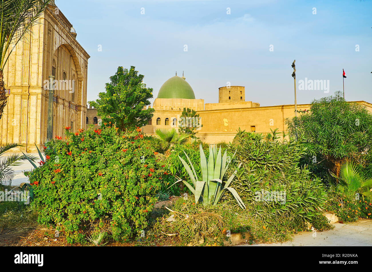 Enjoy the scenic garden of Saladin Citadel with a view on inner walls, tower and the green dome of Al-Nasir Muhammad Mosque, Cairo, Egypt. Stock Photo