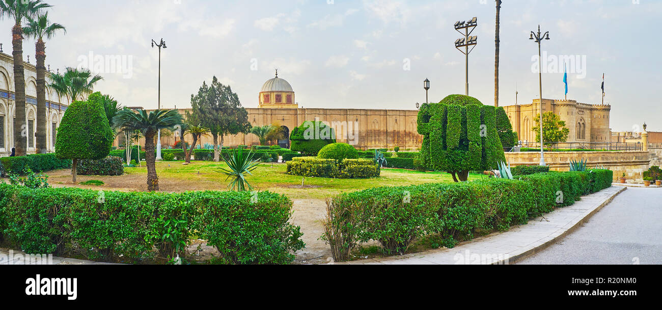 Panorama of the ornamental garden in front of alabaster Mosque with trimmed bushes, shaped with arabic calligraphy (word 'Allah'), Saladin Citadel, Ca Stock Photo