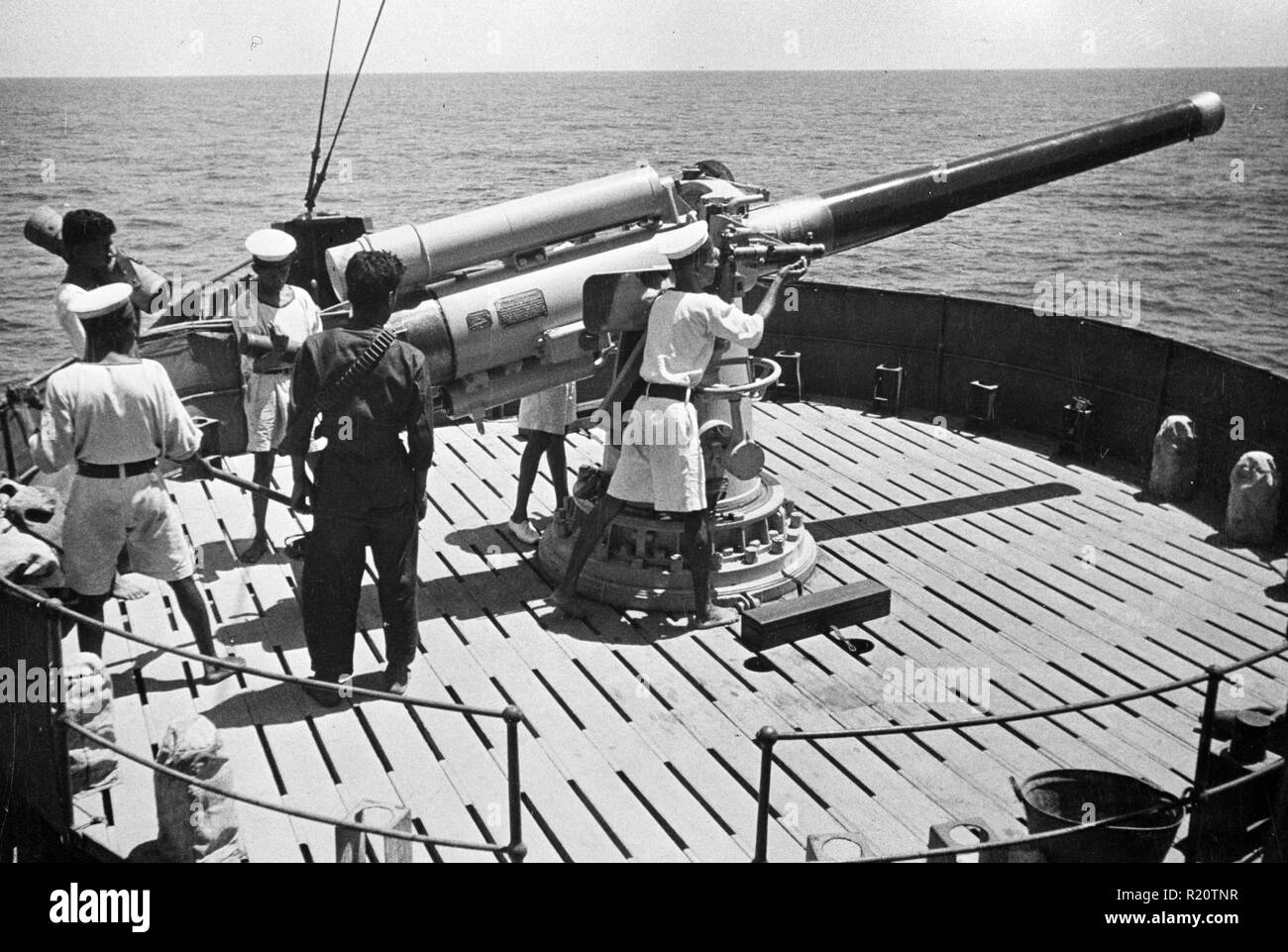 Photograph of On duty with seamen of the Royal Indian Navy on active service in Eastern waters. Captured Italian equipment on board often proves these ships have engaged in successful action World War II. Dated 1942 Stock Photo