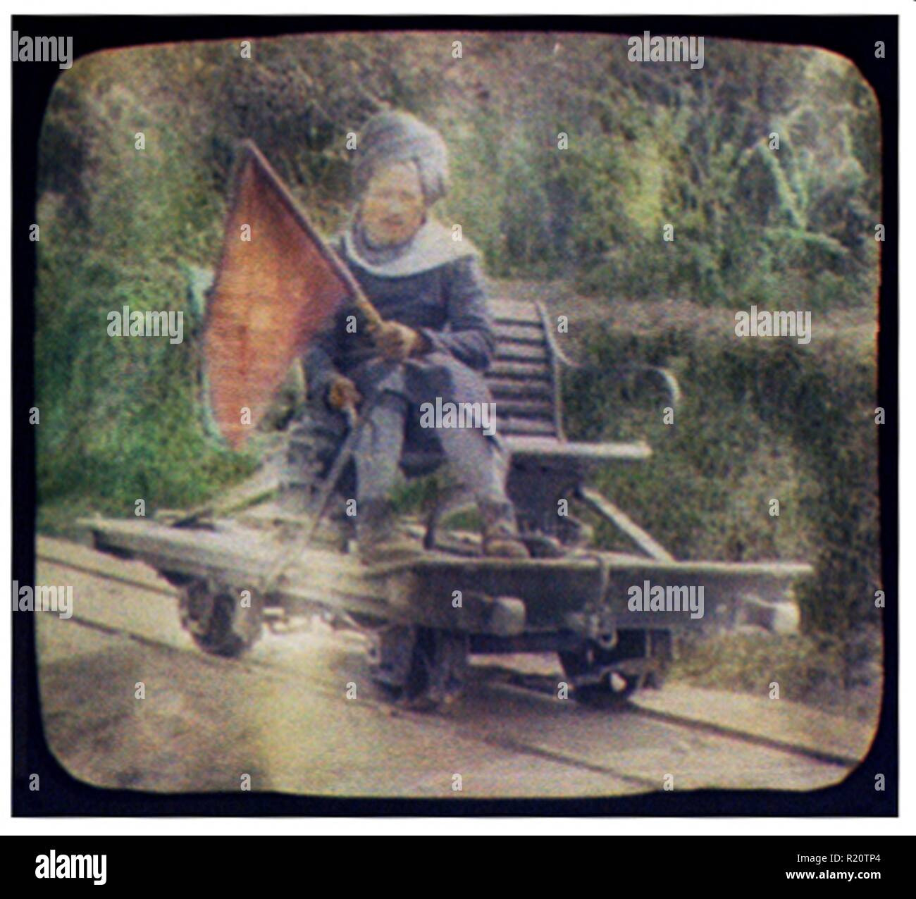 Hand-coloured Photograph of a turbaned man on railway hand car holding red flag, photographed by William Henry Jackson (1843-1942). Dated 1902 Stock Photo