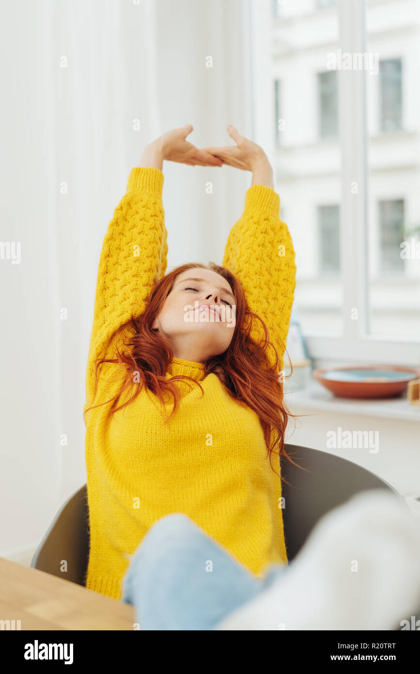 Relaxed Young Woman Stretching With A Blissful Smile And Her Eyes Closed As She Sits In A Comfortable Molded Chair At A Table Or Desk Stock Photo Alamy Relaxed Young Woman Stretching With A Blissful Smile And Her Eyes Closed As She Sits In A Comfortable Molded Chair At A Table Or Desk Stock Photo Alamy