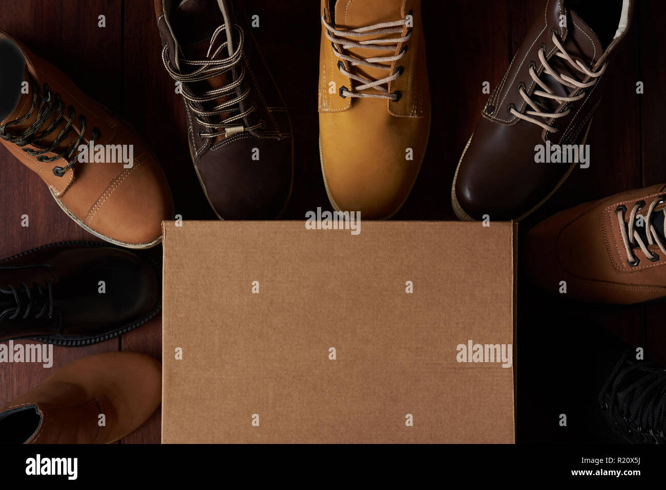 Leather boot theme. Colorful footwear around cartoon box Stock Photo