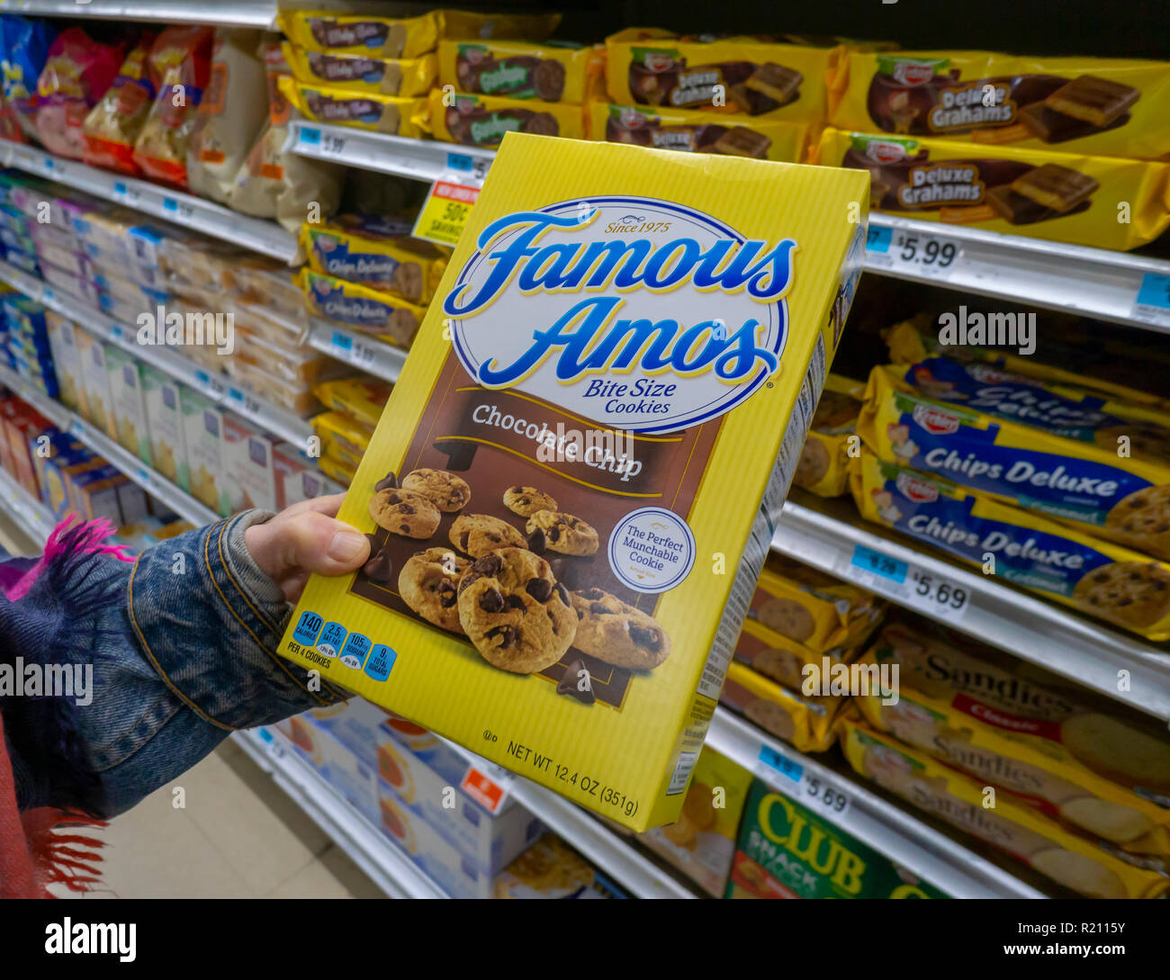 A shopper chooses a package of Kellogg's Famous Amos brand cookies in a supermarket in New York