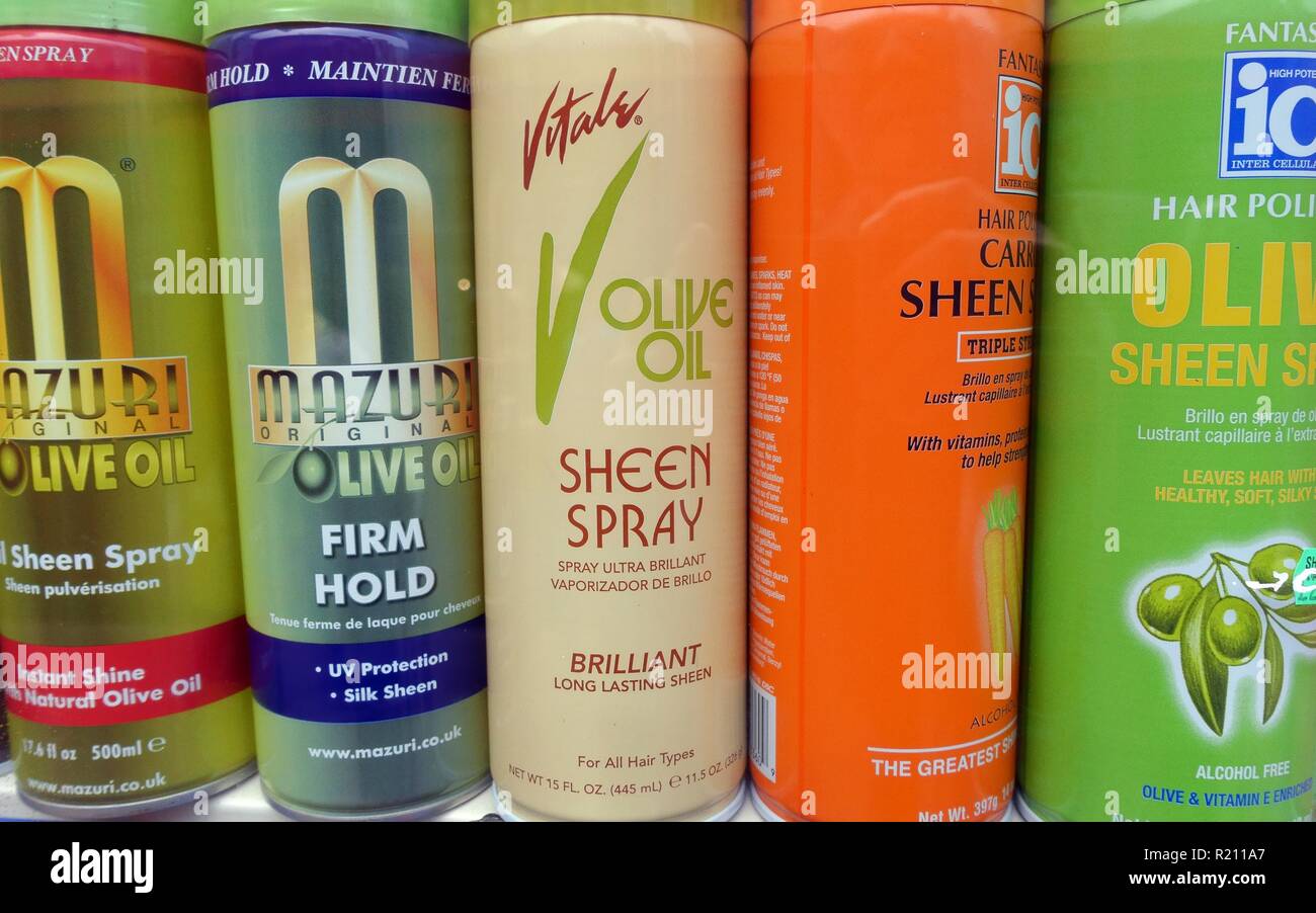 Hairspray aerosols made with olive oil and other vegetables displayed in London beauty products shop Stock Photo