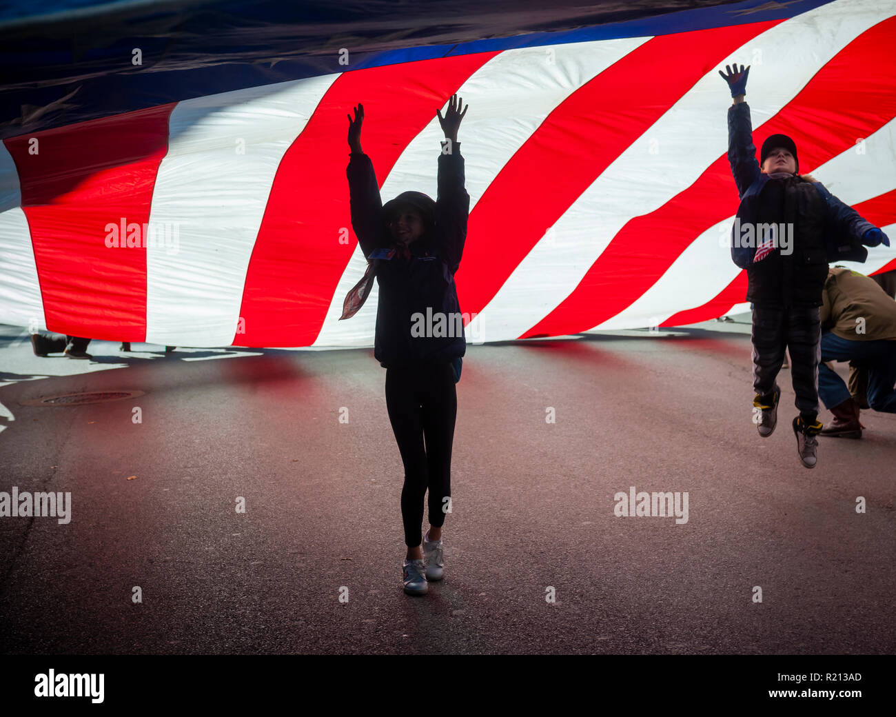 A giant American flag is carried on Fifth Avenue in New York during the Veterans Day Parade on Sunday, November 11, 2018.  Originally knows as Armistice Day, this year the holiday commemorates the 100th anniversary of the end of World War I. On the eleventh hour of the eleventh day of the eleventh month the guns fell silent in 1918 marking the end of World War I.  The holiday has been expanded to include all American soldiers from all wars. (© Richard B. Levine) Stock Photo