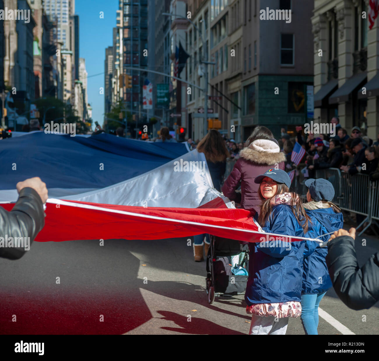 A giant French flag is carried on Fifth Avenue in New York during the Veterans Day Parade on Sunday, November 11, 2018.  Originally knows as Armistice Day, this year the holiday commemorates the 100th anniversary of the end of World War I. On the eleventh hour of the eleventh day of the eleventh month the guns fell silent in 1918 marking the end of World War I.  The holiday has been expanded to include all American soldiers from all wars. (Â© Richard B. Levine) Stock Photo