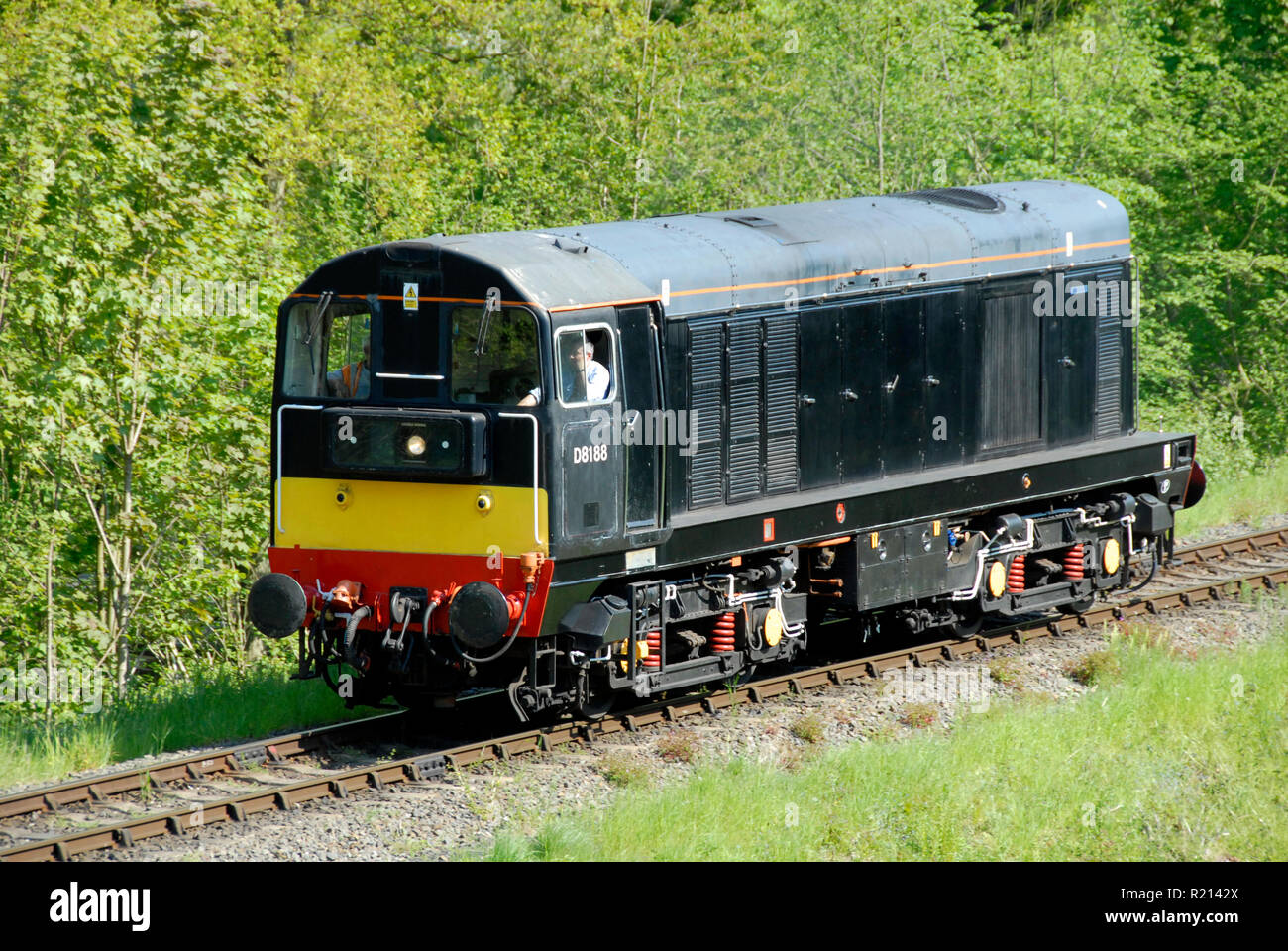 Diesel locomotive on stretch of single-track railway line, England Stock Photo
