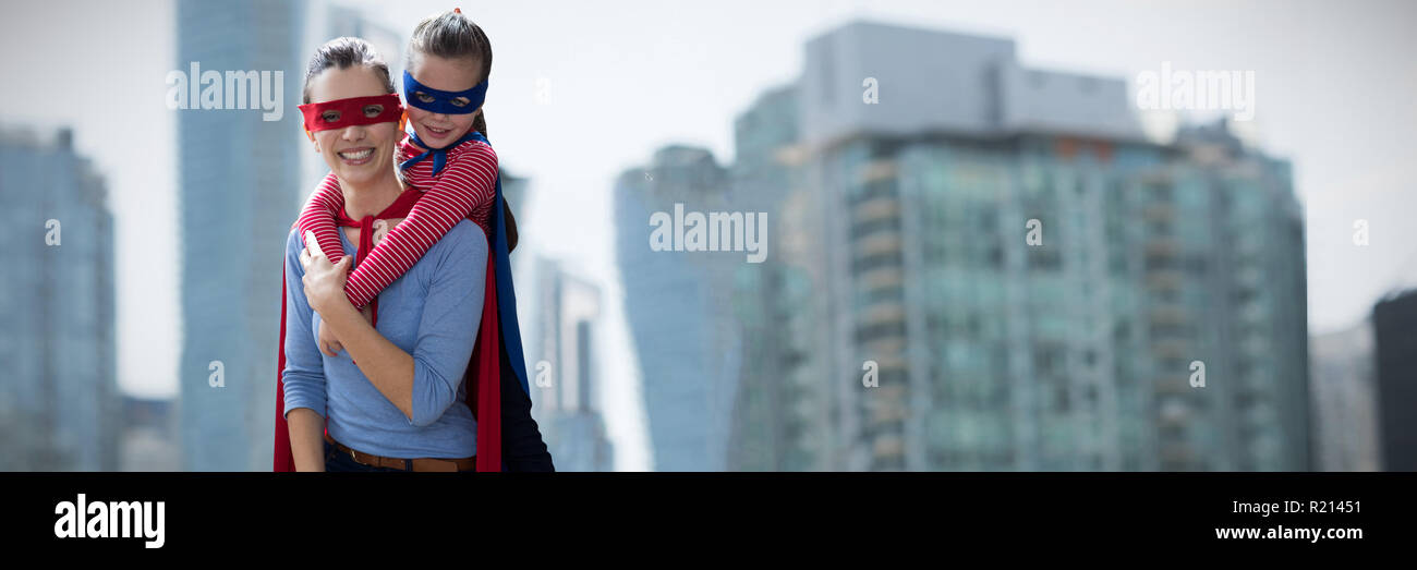 Composite image of mother and daughter pretending to be superhero Stock Photo