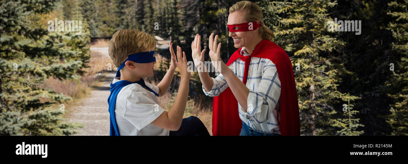 Composite image of mother and son pretending to be superhero Stock Photo