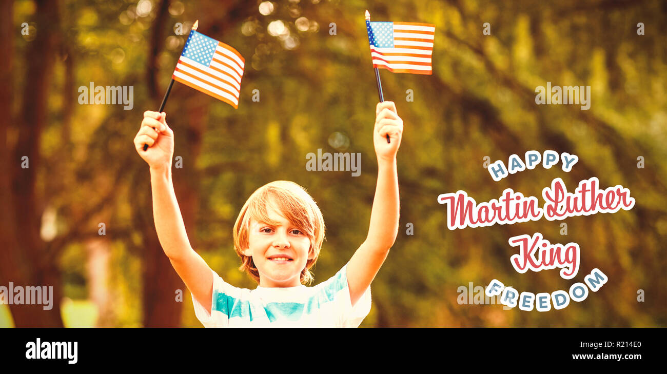 Composite image of portrait of boy showing american flags Stock Photo