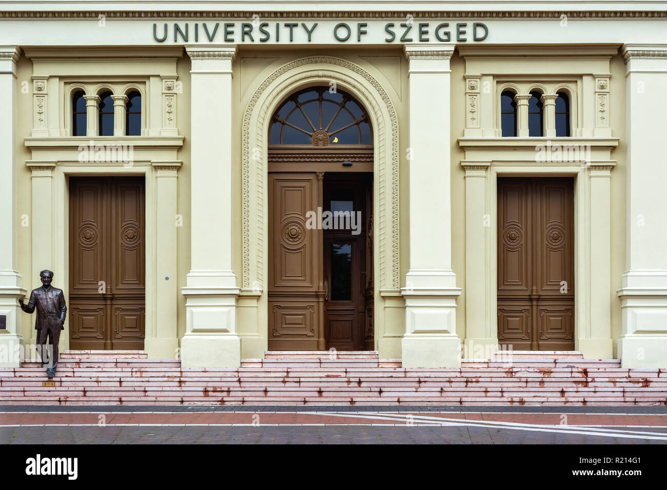 Szeged, Hungary, June 28: Image of the main entrance to the building of the University of Szeged with a figure depicting a teacher standing on the ste Stock Photo