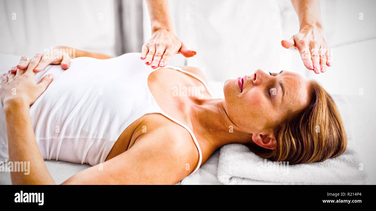 Woman receiving reiki treatment Stock Photo