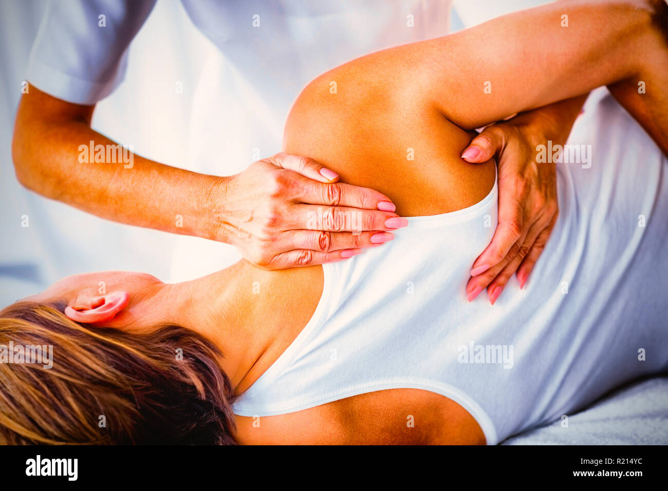 Cropped image of human hand massaging female shoulder Stock Photo