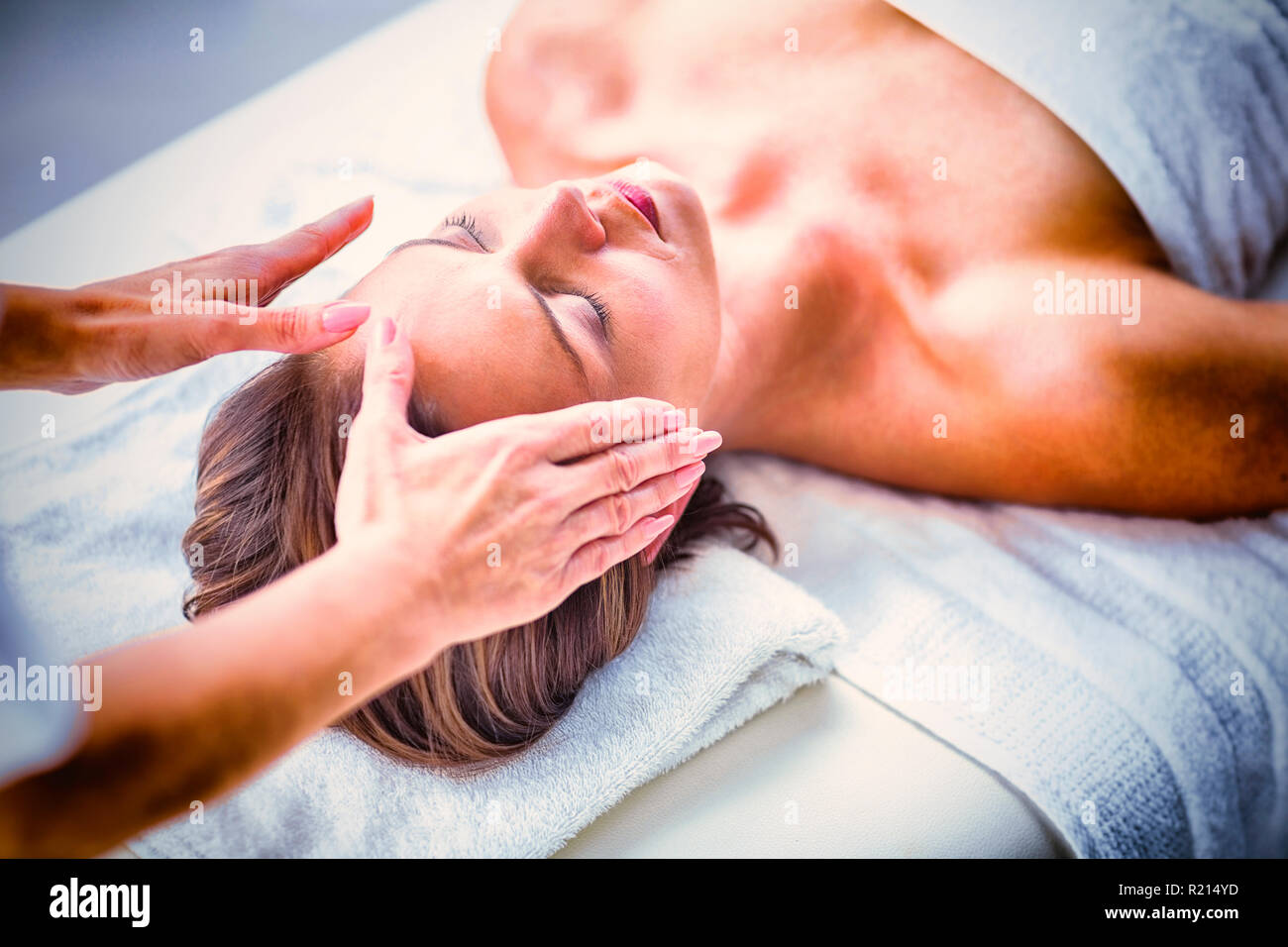 Cropped hands of therapist performing reiki on woman Stock Photo