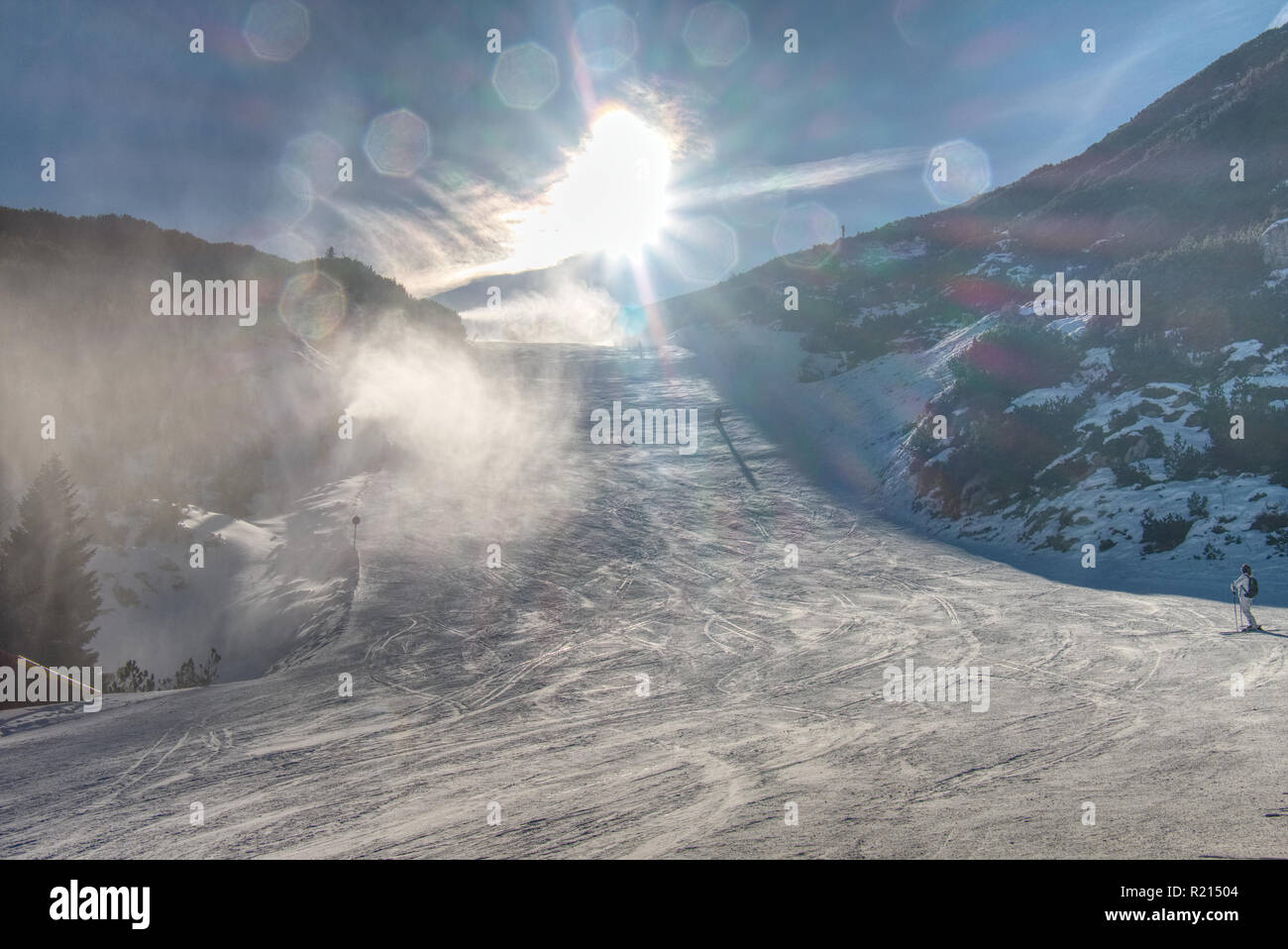 Snow maker machine works (snow gun or snow cannon) at ski slopes resort