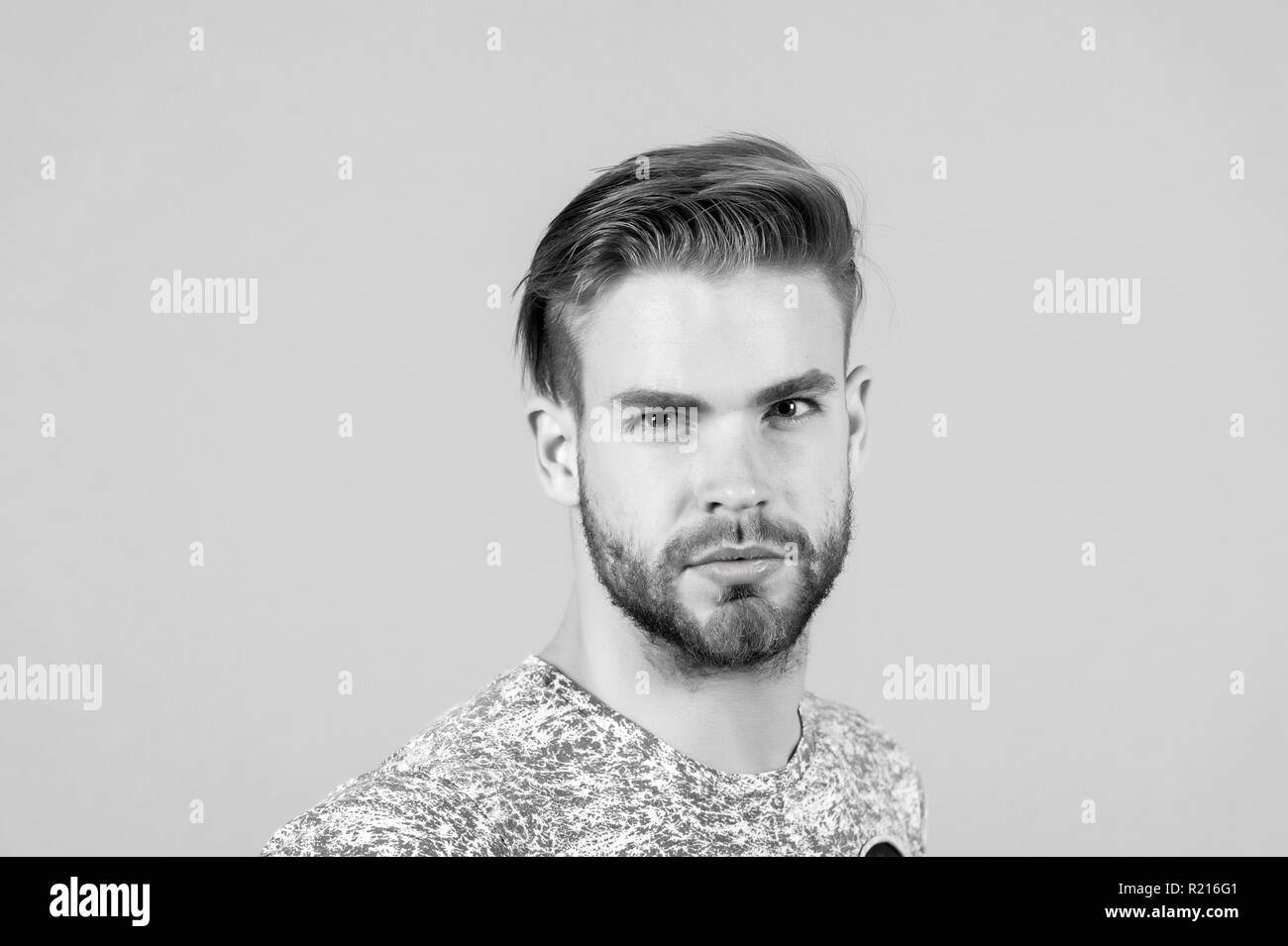 Macho with bearded face, beard. Man with blond hair, haircut. Grooming and  hair care in beauty salon barbershop. Fashion, style and trend concept  Stock Photo - Alamy
