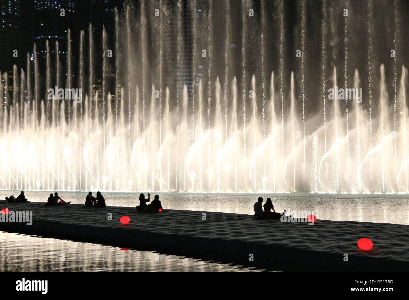 DUBAI, UAE - NOVEMBER 22, 2017: People visit the fountain show in Dubai. The Dubai Fountain is the world's 2nd largest choreographed fountain system. Stock Photo