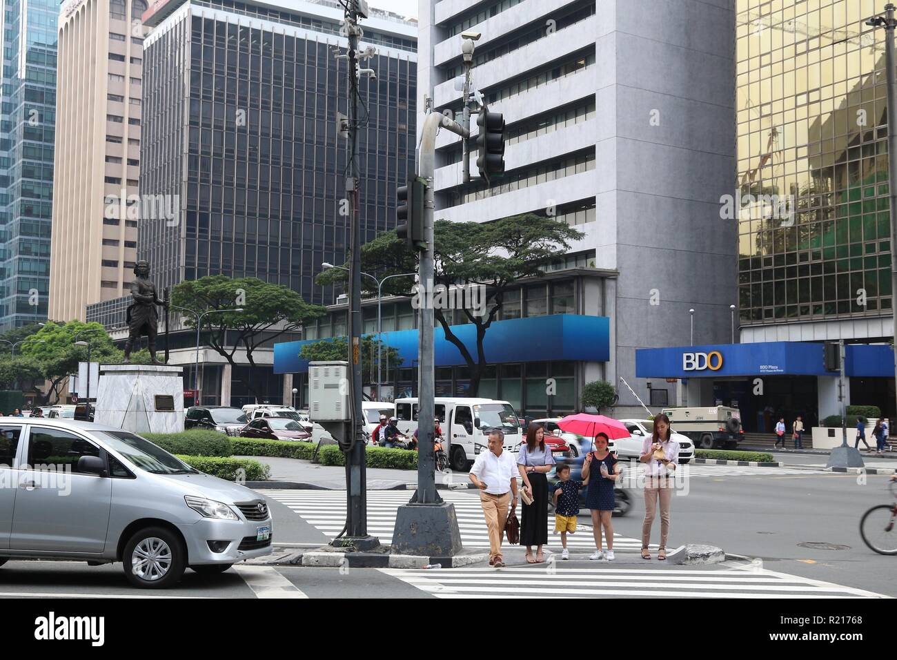 MANILA, PHILIPPINES - DECEMBER 7, 2017: People visit Makati City, Metro Manila, Philippines. Metro Manila is one of the biggest urban areas in the wor Stock Photo