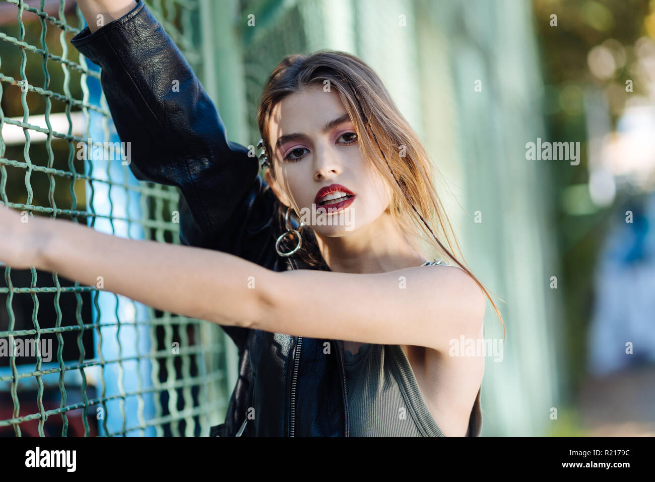 Fashionable trendy model wearing khaki shirt and leather jacket Stock