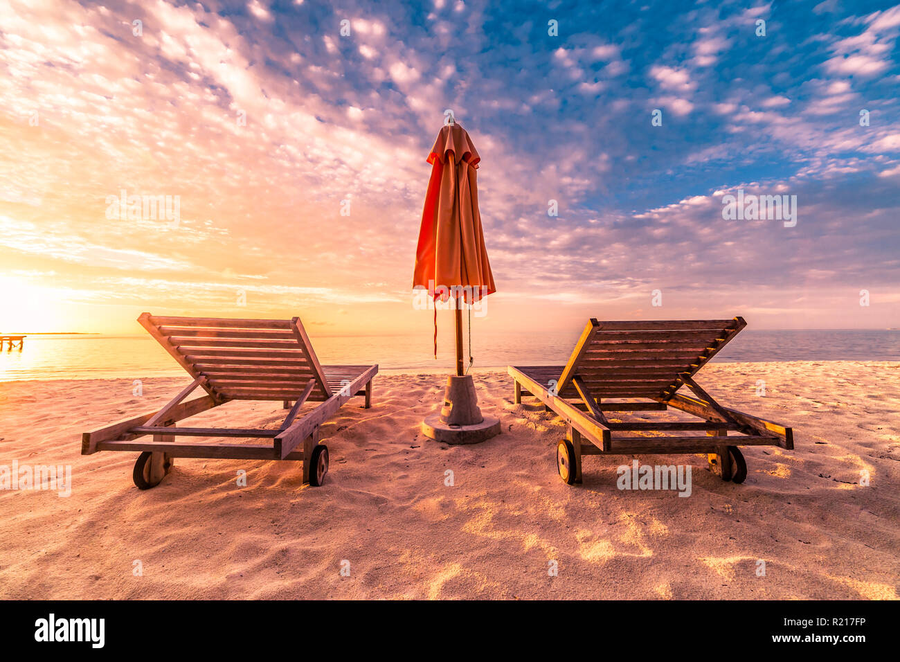 Romantic beach scene, two sun chairs and sunny beach mood. Exotic travel destination and vacation concept Stock Photo