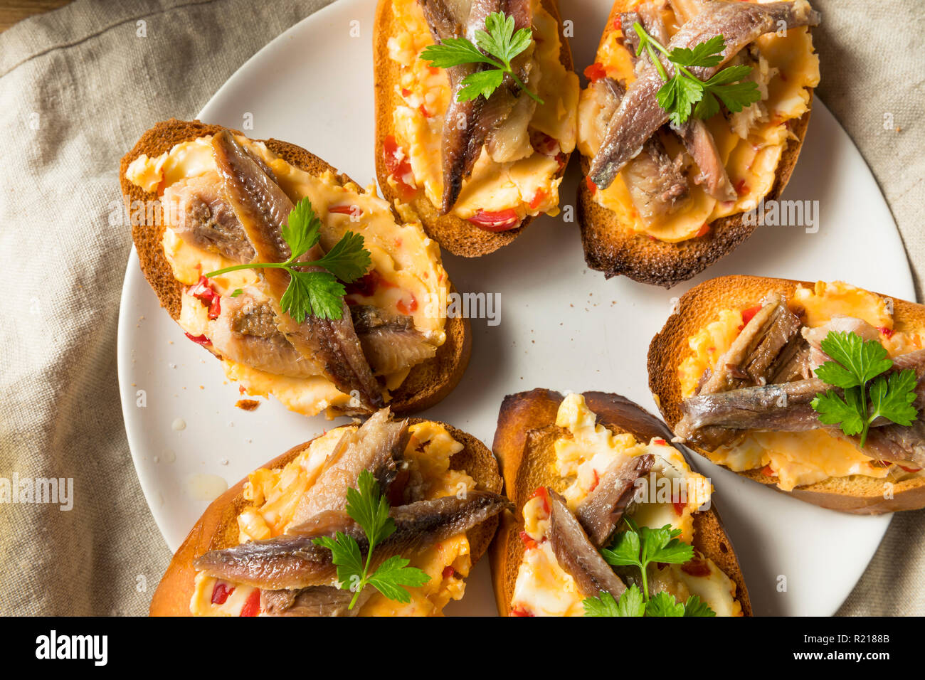 Homemade Anchovy and Sardine Crostini with Spicey Butter Stock Photo