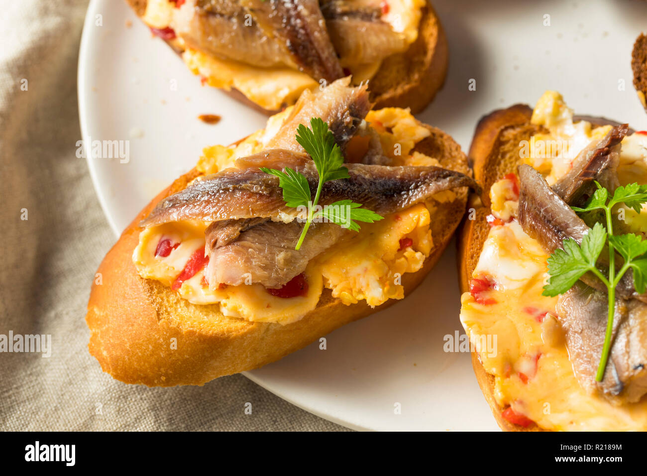 Homemade Anchovy and Sardine Crostini with Spicey Butter Stock Photo