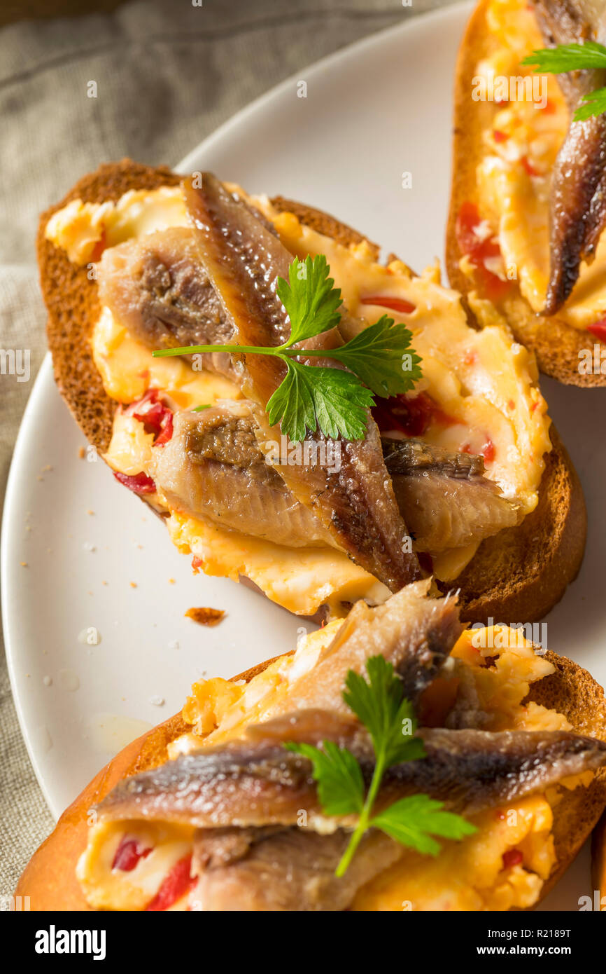 Homemade Anchovy and Sardine Crostini with Spicey Butter Stock Photo