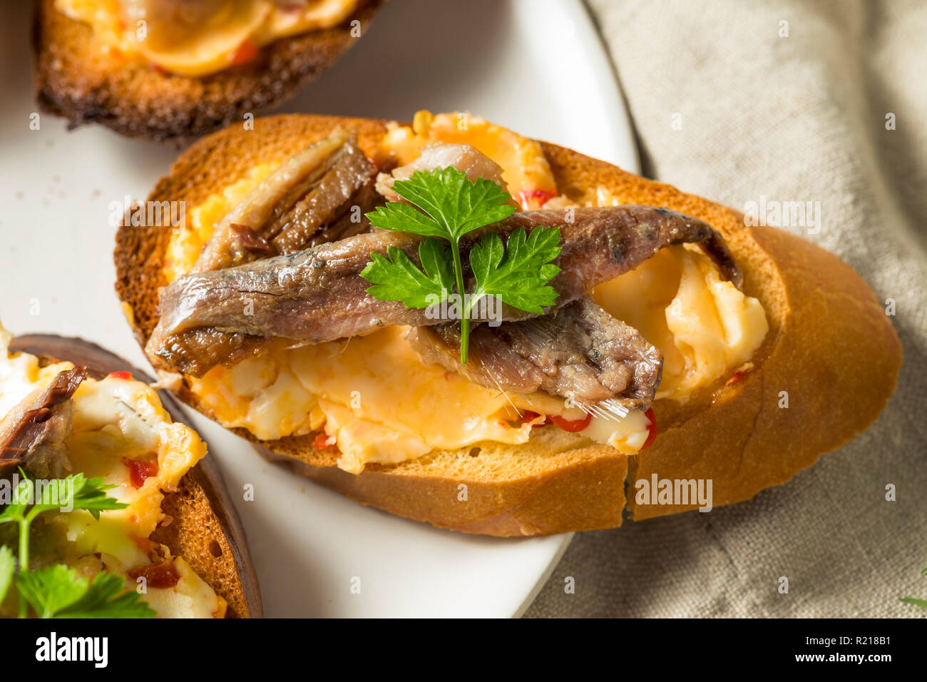 Homemade Anchovy and Sardine Crostini with Spicey Butter Stock Photo