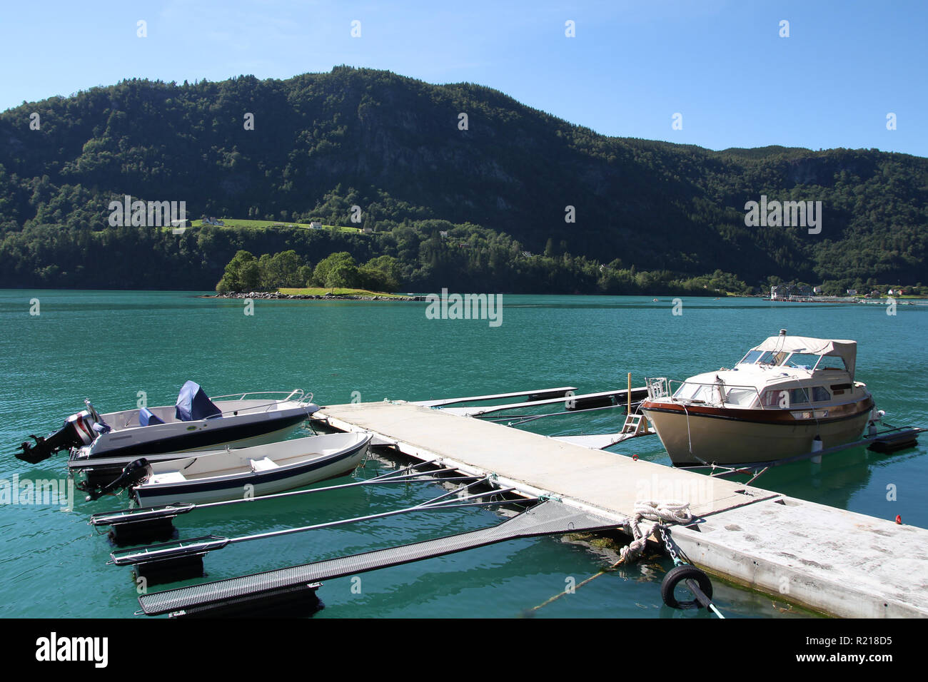 Norway - Hardangerfjord marina with anchored motorboats. Seaside landscape. Stock Photo