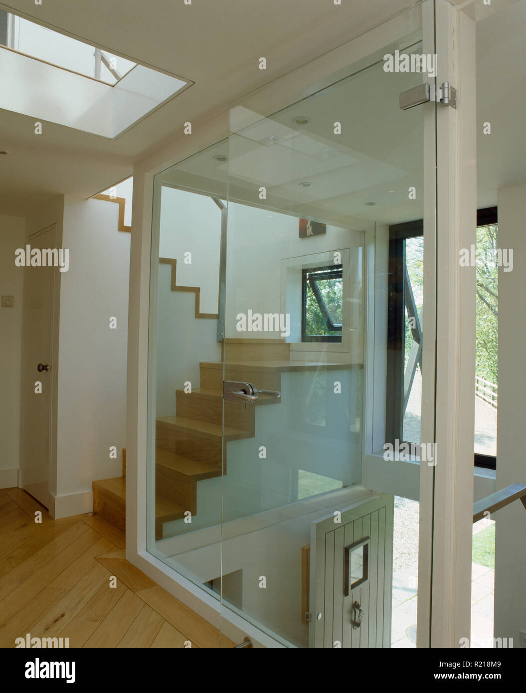 View of stairs thgrough glass wall on modern landing Stock Photo