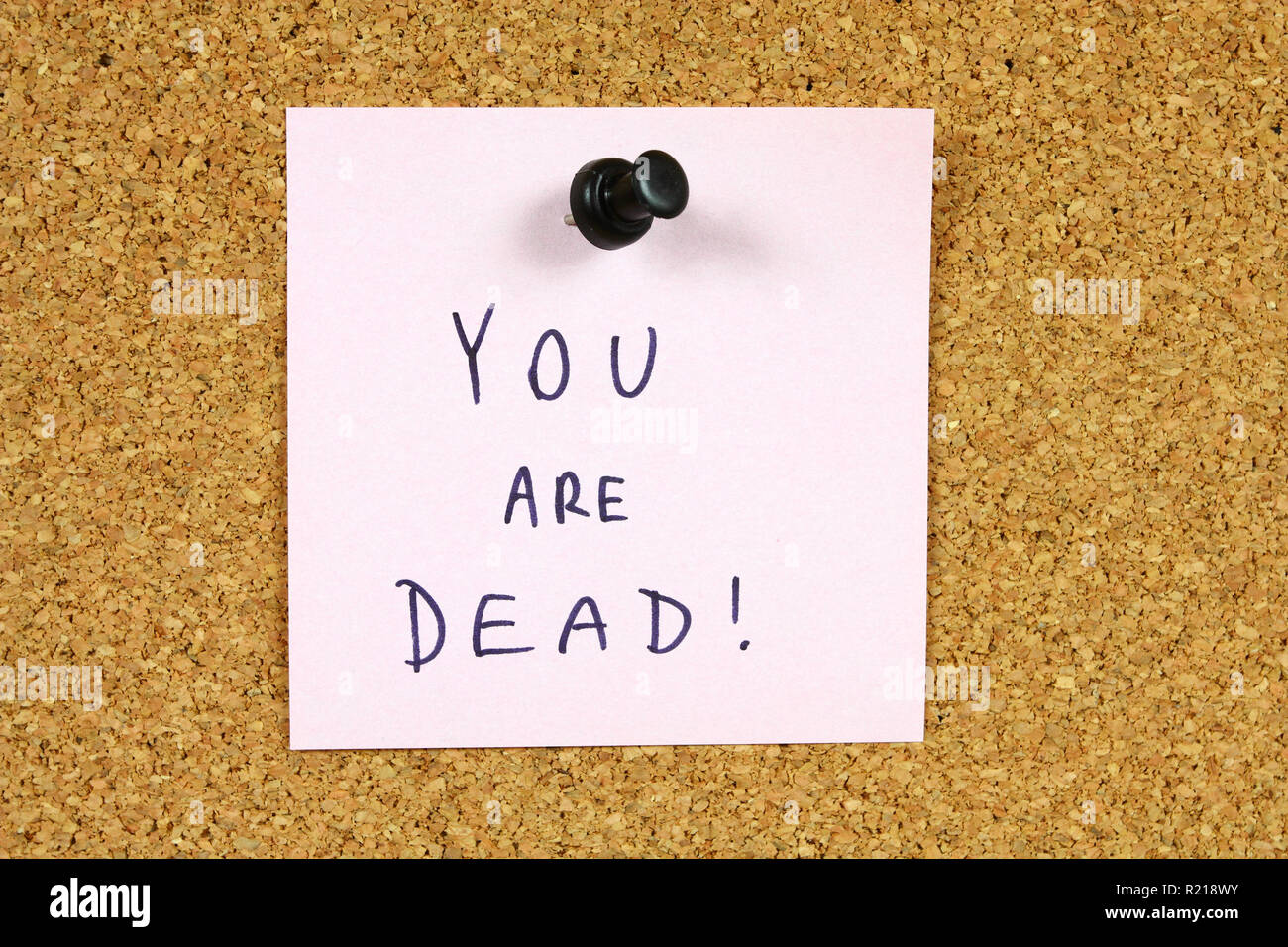 Pink sticky note pinned to an office notice board. You are dead death